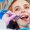 Portrait of an attractive smiling redhaired ginger customer girl in a dental chair in dental cabinet.She is not fear .